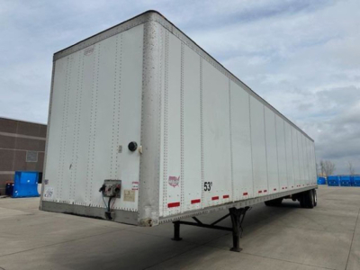 Trailer side view showing a white 53' Wabash van trailer with rear doors, corner post, and support legs visible.