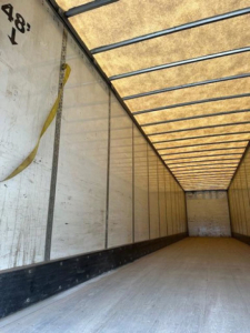 Interior of a 2014 Wabash van trailer showing empty cargo space with white side walls and a ribbed ceiling.