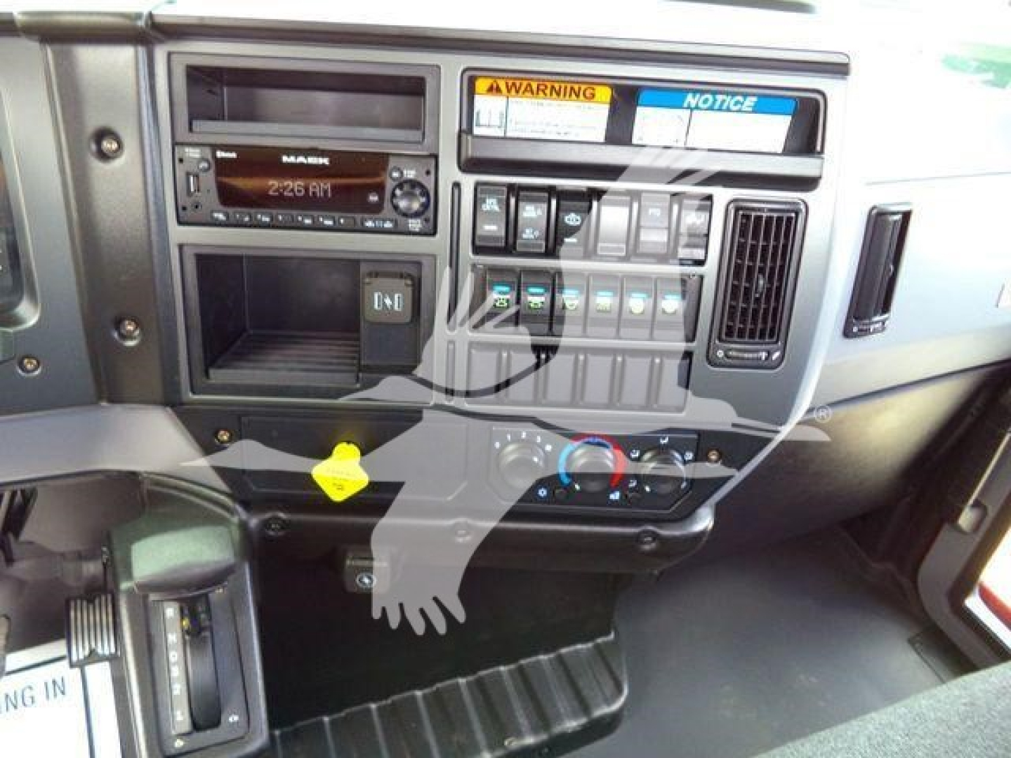 Dashboard interior of a 2026 Mack MD6 showing radio, control switches, climate controls, and multiple gauges.