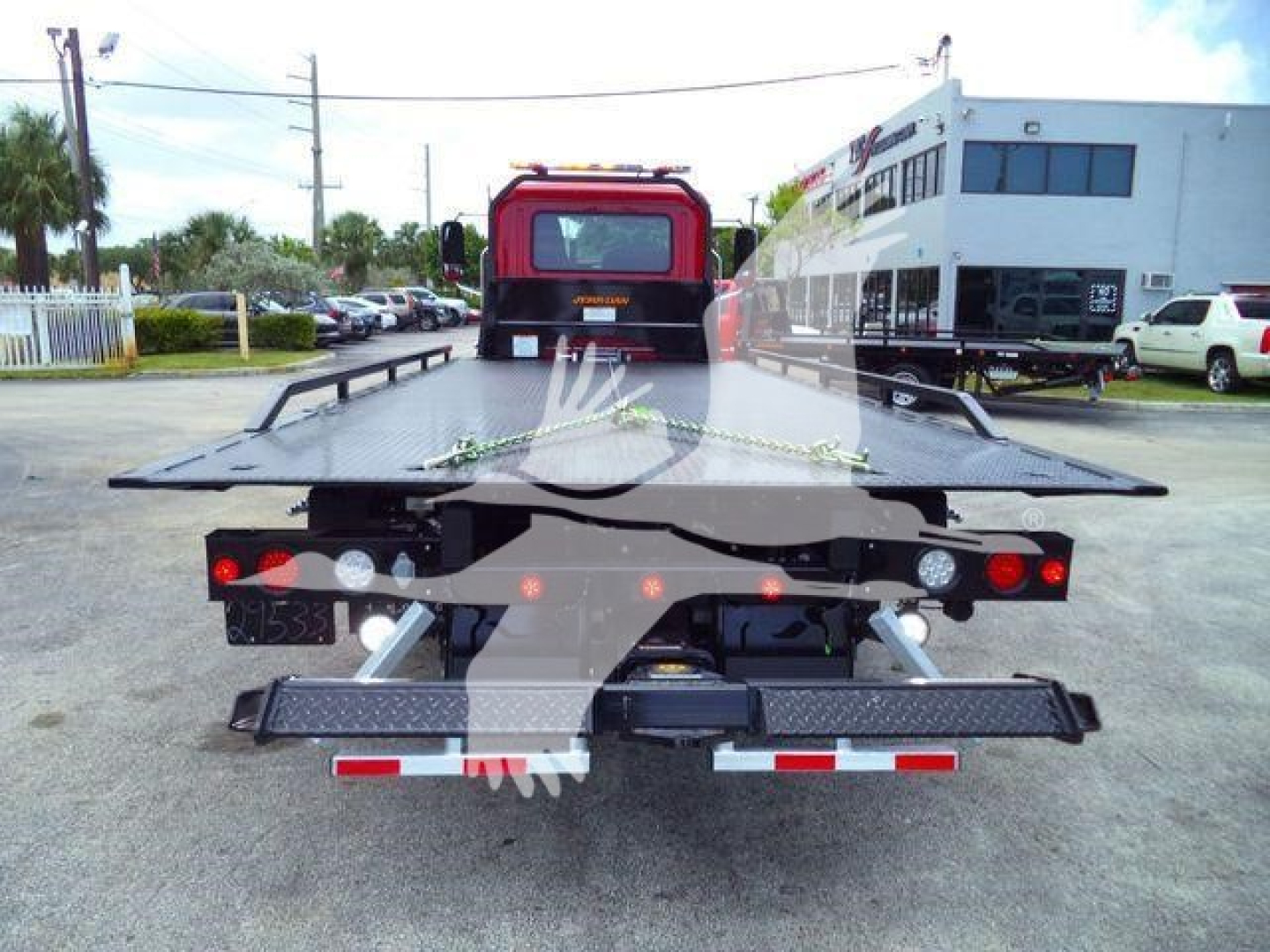 MD6 rollback truck bed showing heavy-duty flatbed with wheel-lift apparatus and rear lights.