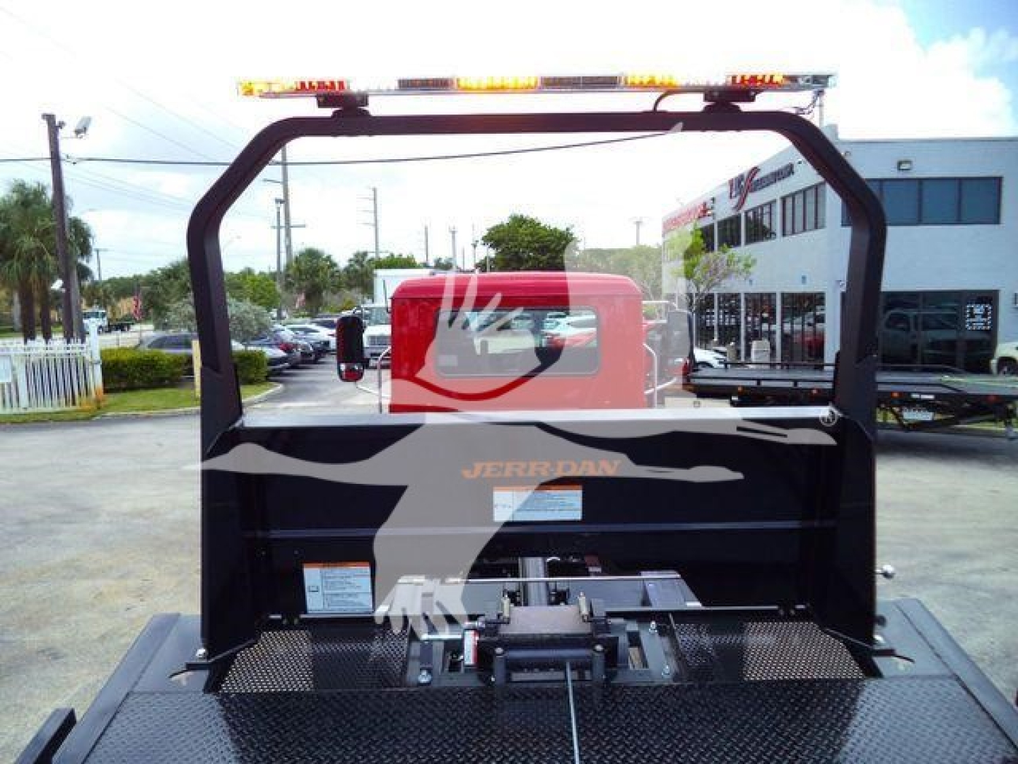 Mack MD6 rollback truck bay view showing rear frame and mounting hardware with a red cab visible through the back window