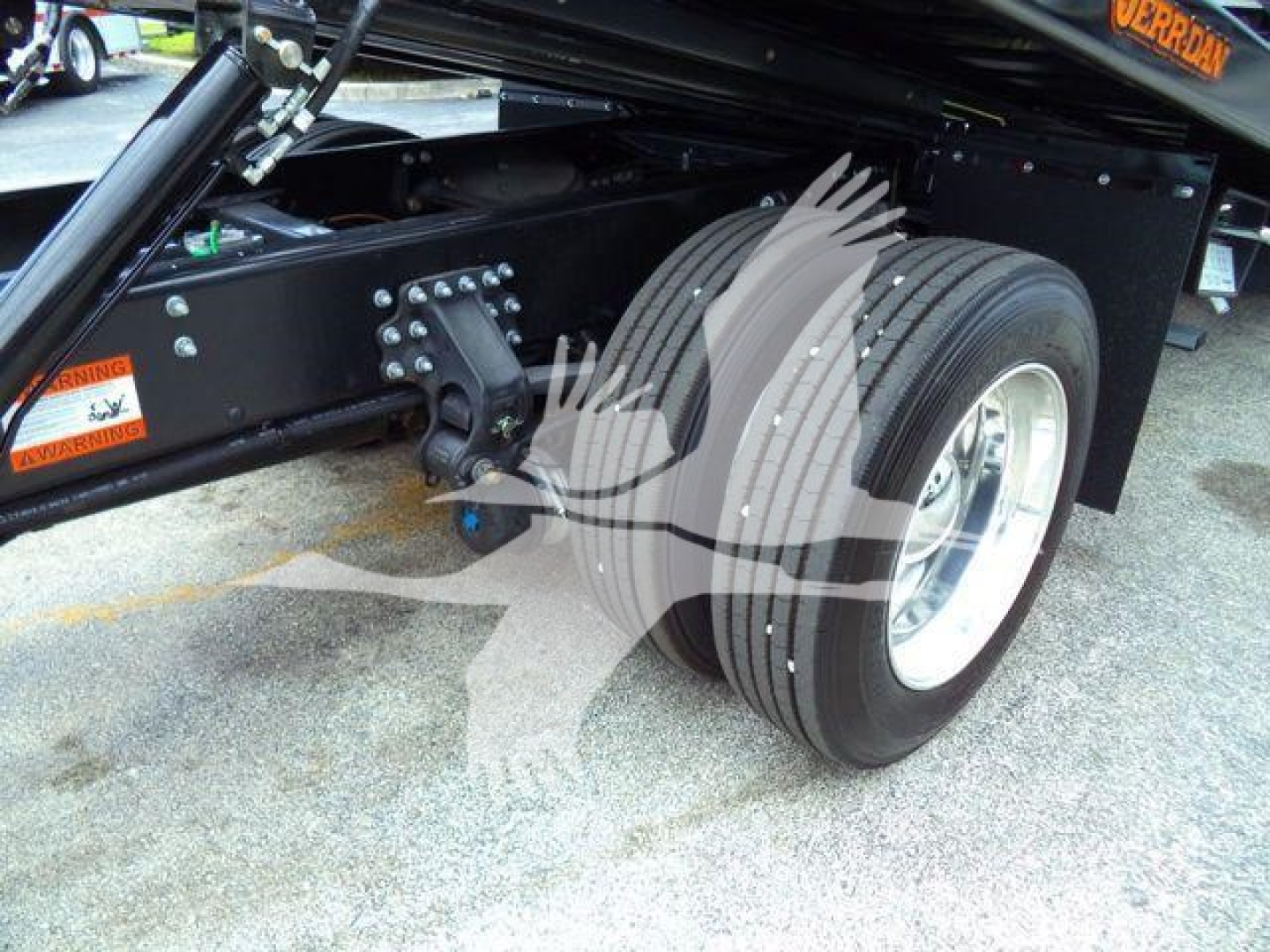 Mack MD6 rollback truck chassis showing dual rear wheels and hitch area with metal frame and labeling.
