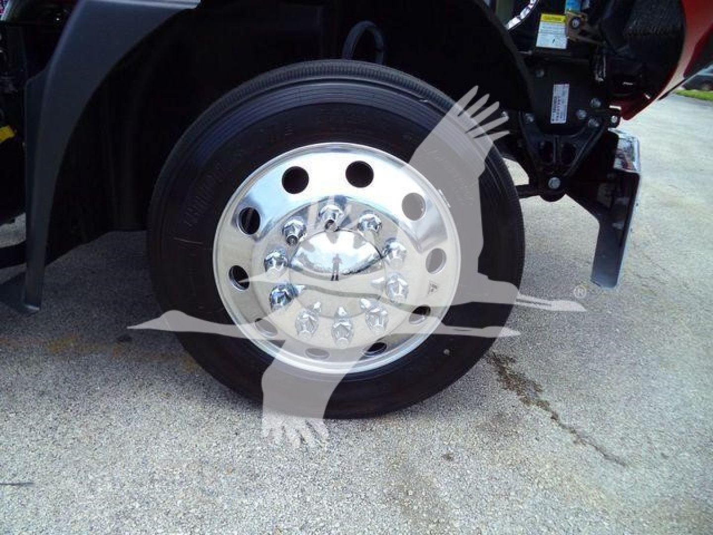 Wheel and hub of a 2026 Mack MD6 truck showing polished chrome wheel with multiple lug nuts and tire sidewall.
