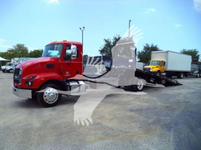 Red 2026 Mack MD6 rollback truck with a white cab and attached trailer, viewed from the side in a dealership lot.