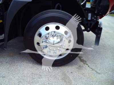 Wheel and hub of a 2026 Mack MD6 truck showing polished chrome wheel with multiple lug nuts and tire sidewall.
