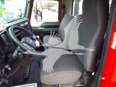 MD6 truck cab interior showing driver's seat and steering wheel with gray fabric upholstery.