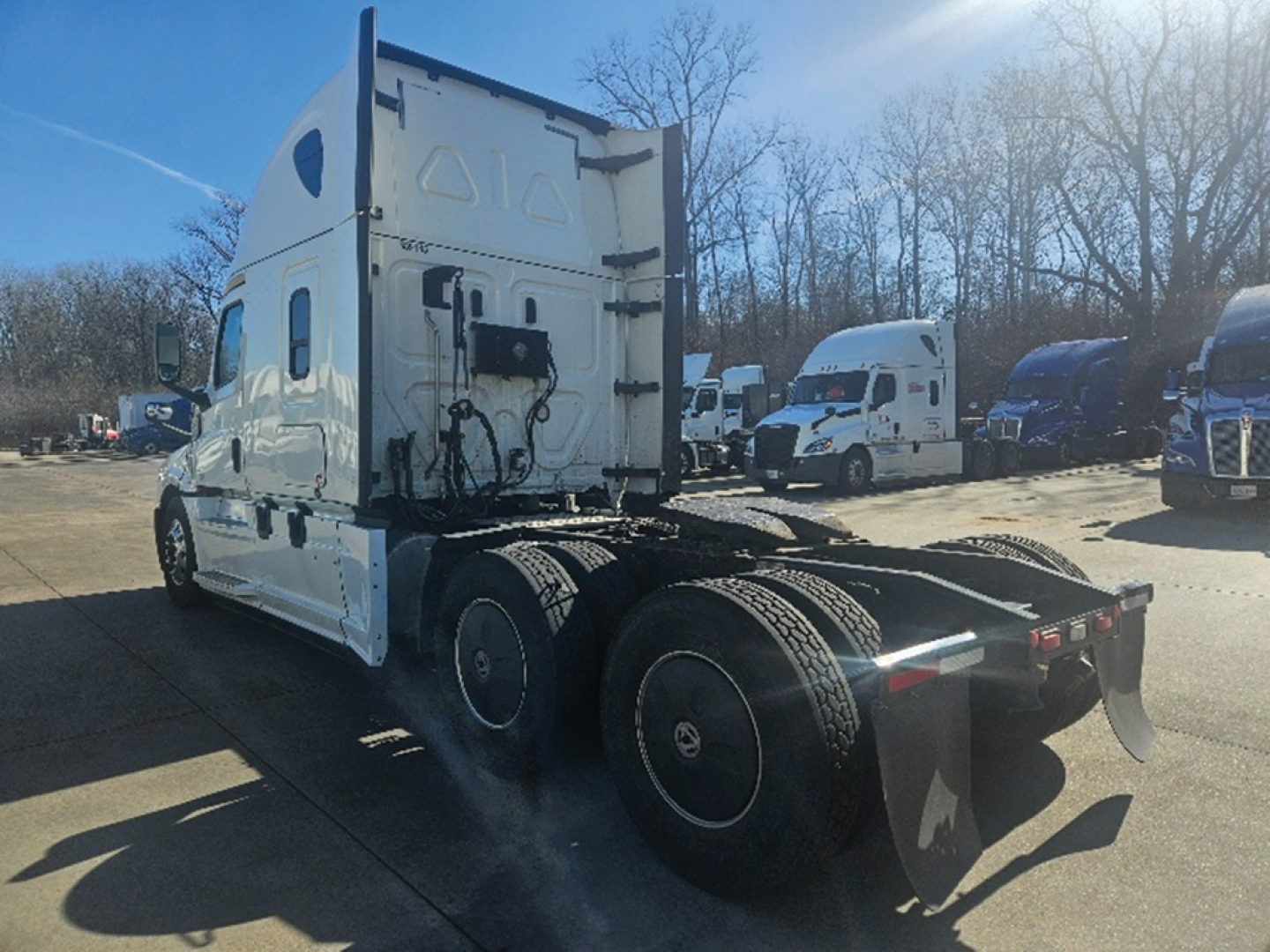 Truck rear and side view showing sleeper cab, tandem axles, and fifth wheel mounting on a Freightliner Cascadia126.