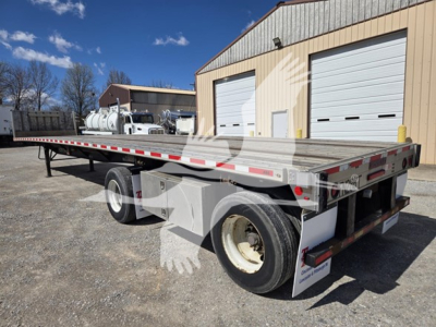 Flatbed trailer: 2019 Fontaine Infinity flatbed trailer showing dual rear axle, long aluminum deck, reflectors, and rear underride guards.
