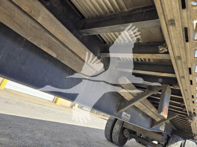 Flatbed trailer undercarriage showing structural steel frames and wheel assembly with Fontaine logo watermark.