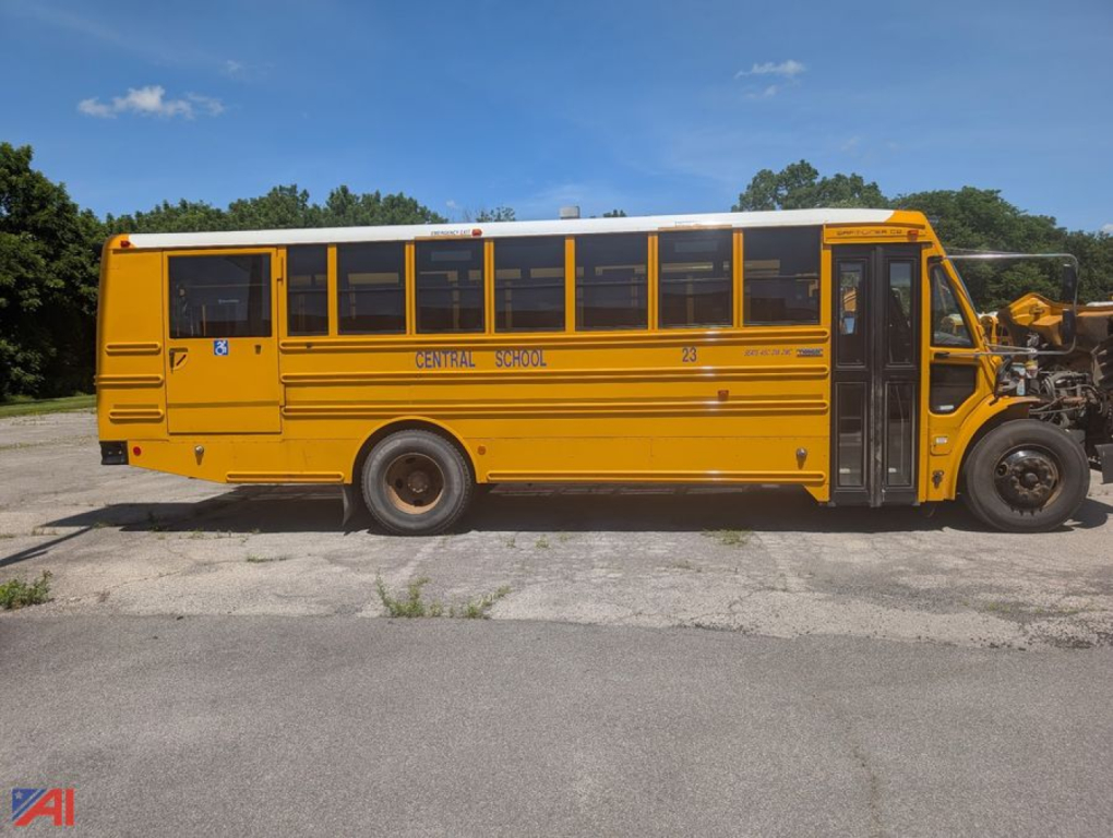 Yellow school bus side view showing Central School lettering, OEM doors, and wheel wells.