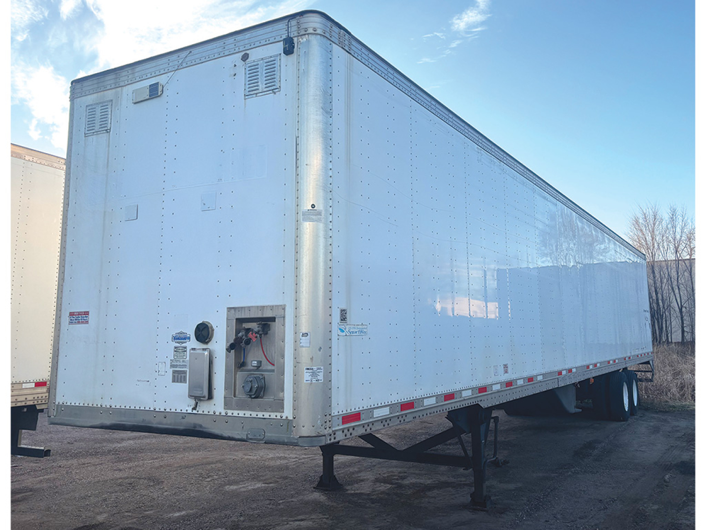 Ultralight aluminum Vanguard van trailer with riveted panels, showing front control box and rear corner with vents and lighter access.