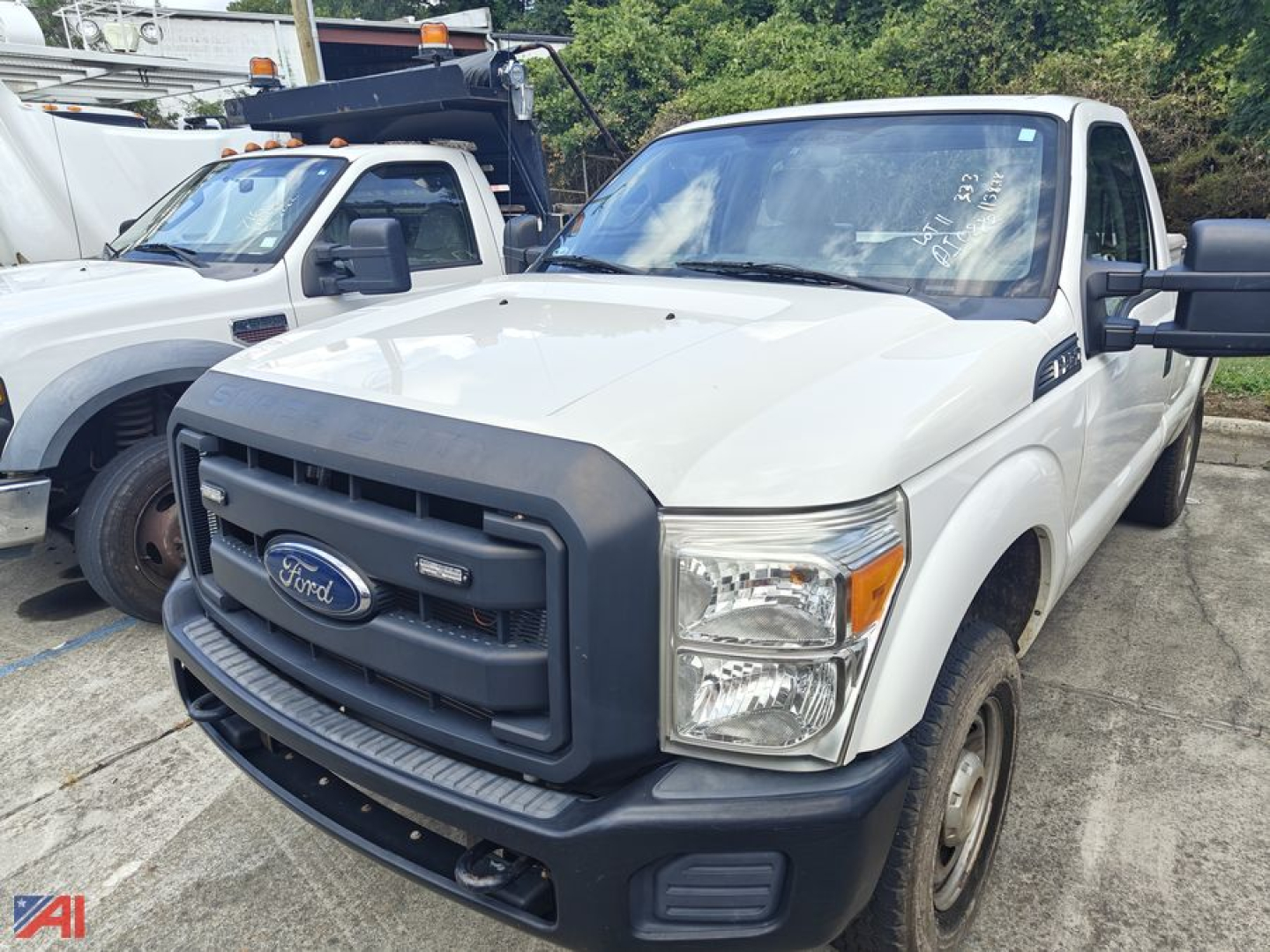 White 2016 Ford F-250 pickup truck front-left view with black grille guard and extended cab, in a used lot.
