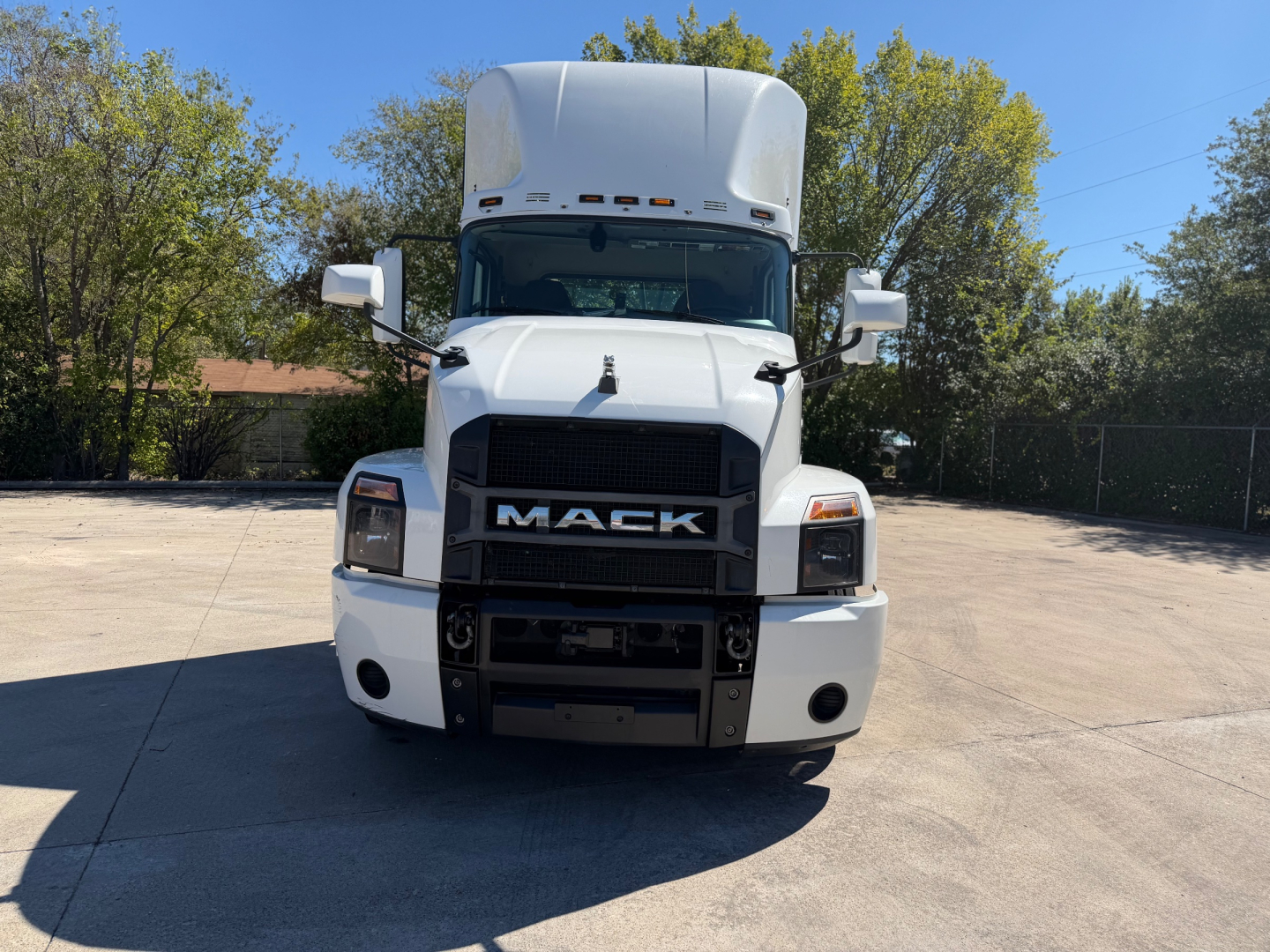 Mack anthem 64T truck front view showing grille with MACK logo and large bumper.
