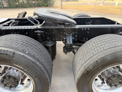 Truck chassis showing dual rear axles with air suspension and rear frame, Mack ANTHEM 64T; visible tires and rims; drivetrain area; front cab not visible.