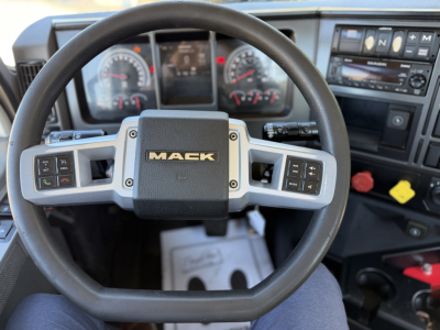 Mack ANTHEM 64T truck cockpit interior showing steering wheel with Mack logo and instrument cluster.