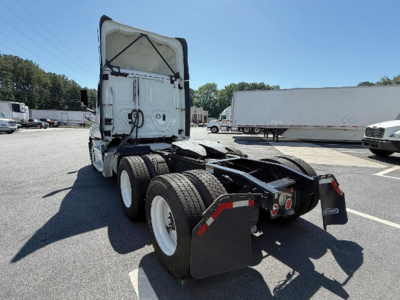 Truck rear view showing chassis and dual rear axles with mud flaps and fifth wheel area