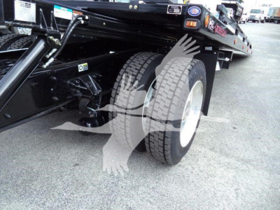 Kenworth T280 rollback truck showing dual rear wheels and undercarriage components.