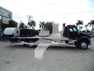 Kenworth T280 rollback truck on lot with flatbed and tow dolly, VIN 2NK3HM6XXSM140823, stock J40823, new unit.