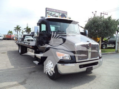 Kenworth T280 rollback truck showing front view and flatbed cargo area with chrome grille and large mirrors