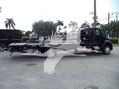 Kenworth T280 rollback truck side view showing carrier frame and cab with flatbed payload area.