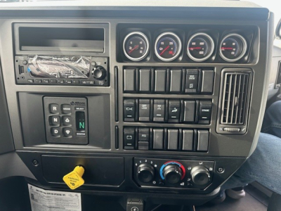Dashboard of a 2026 Mack GR64F truck showing multiple gauges and control switches in the instrument panel.
