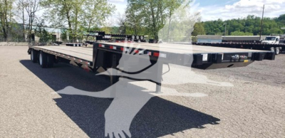  trailer bed showing a Dorsey beavertail lowboy deck with multiple axles and black frame, side rails, and rear ramps in an outdoor lot.