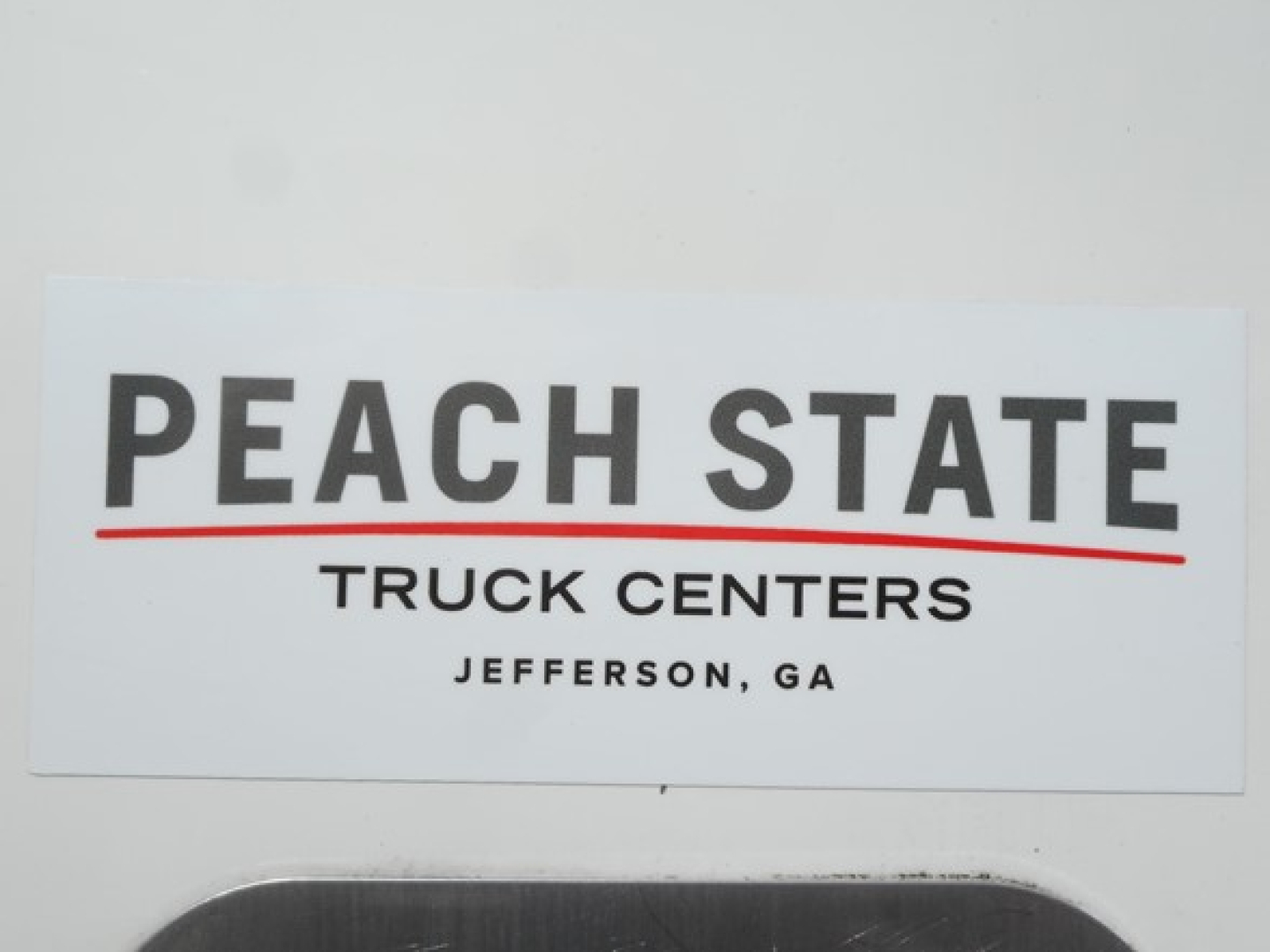 Peach State Truck Centers sign with PEACH STATE text and JEFFERSON, GA below.