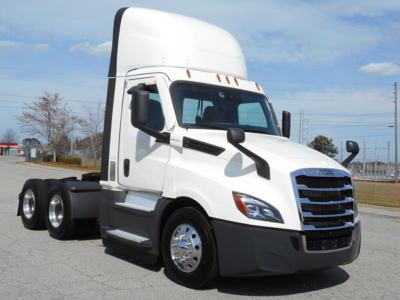 Truck cab showing Freightliner Cascadia 126 day cab with white exterior and black bumper, front view.