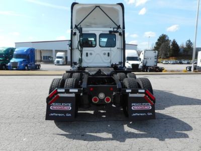 Truck chassis rear view showing fifth wheel and mud flaps with Peach State Freightliner Jefferson, GA text.