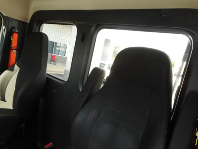  Freightliner Cascadia 126 interior view showing driver seats and side window.