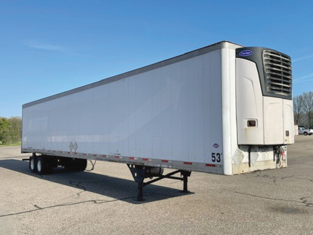 Semi trailer with reefer cooling unit at front, white box body, tandem wheels, 53 ft length, parked on lot.