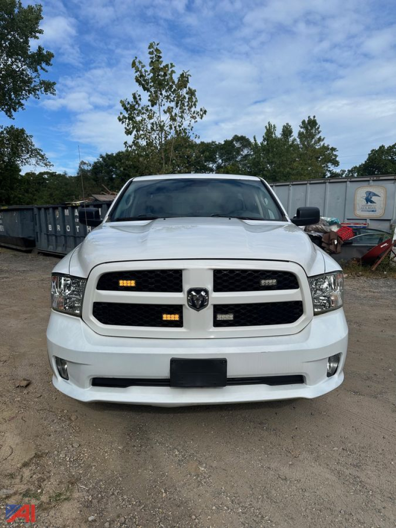 Ram pickup truck front view showing grille with RAM emblem and headlights, white factory bumper, Dodge Ram 1500 DS 2017 style.