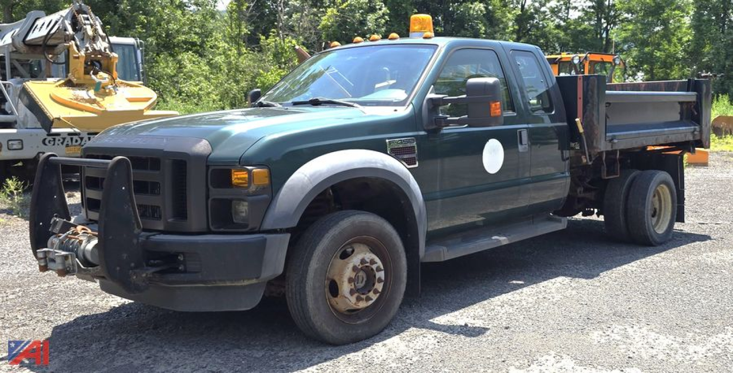 Ford F-450 Super Duty XL dump truck, extended cab, front view with pusher bumper and dump bed, used condition.