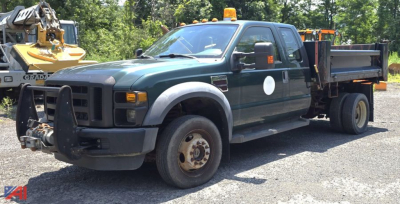 Ford F-450 Super Duty XL dump truck, extended cab, front view with pusher bumper and dump bed, used condition.