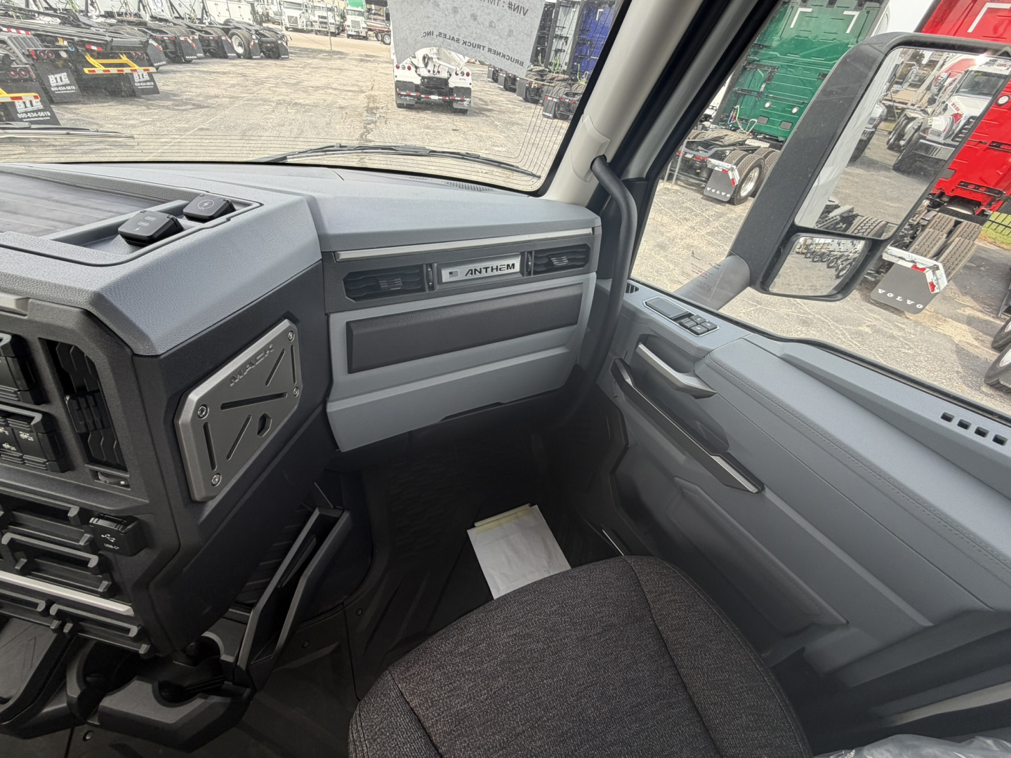 Cabin interior of a 2027 Mack AN64T truck showing dashboard and steering area with 'ANTHIM' branding on panel.