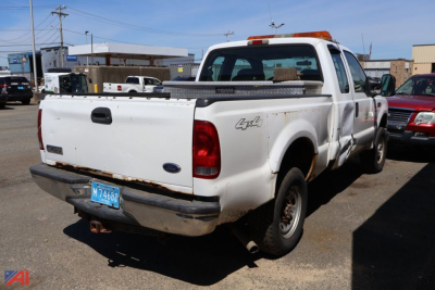 Ford F-250 Super Duty pickup rear view showing bed with toolbox, taillights, and license plate.