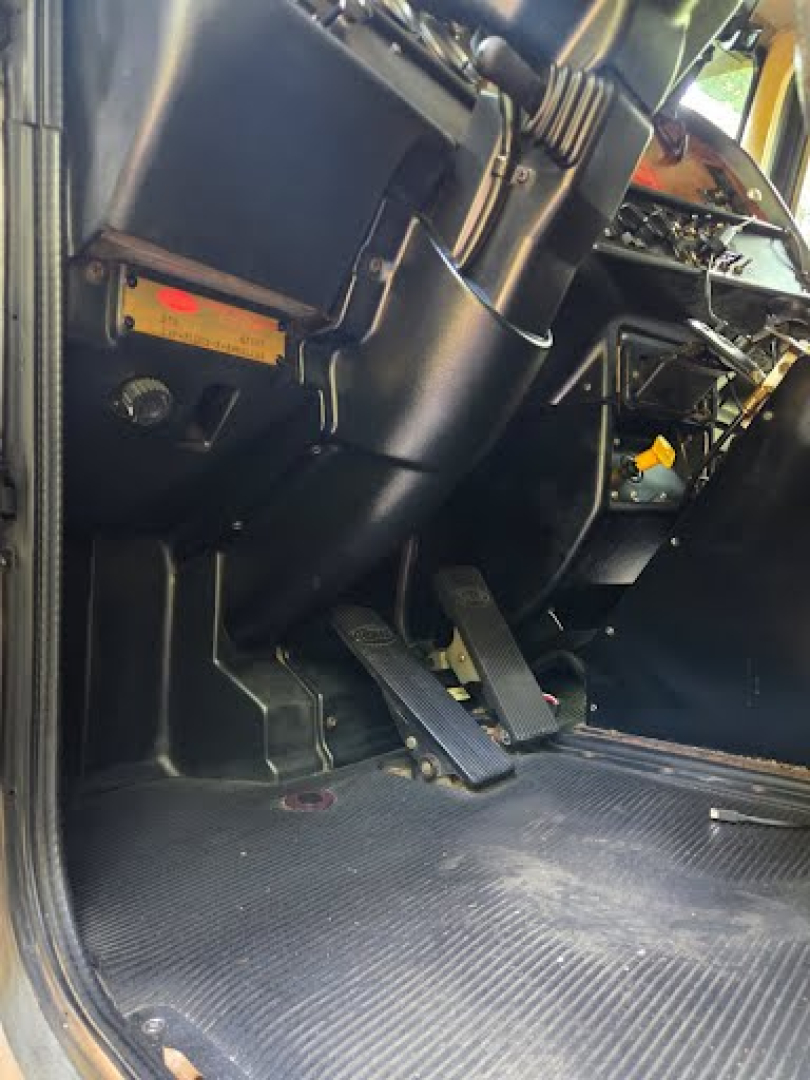 Peterbilt 378 dump truck interior pedal area and dashboard view showing floor pedals and control panels.