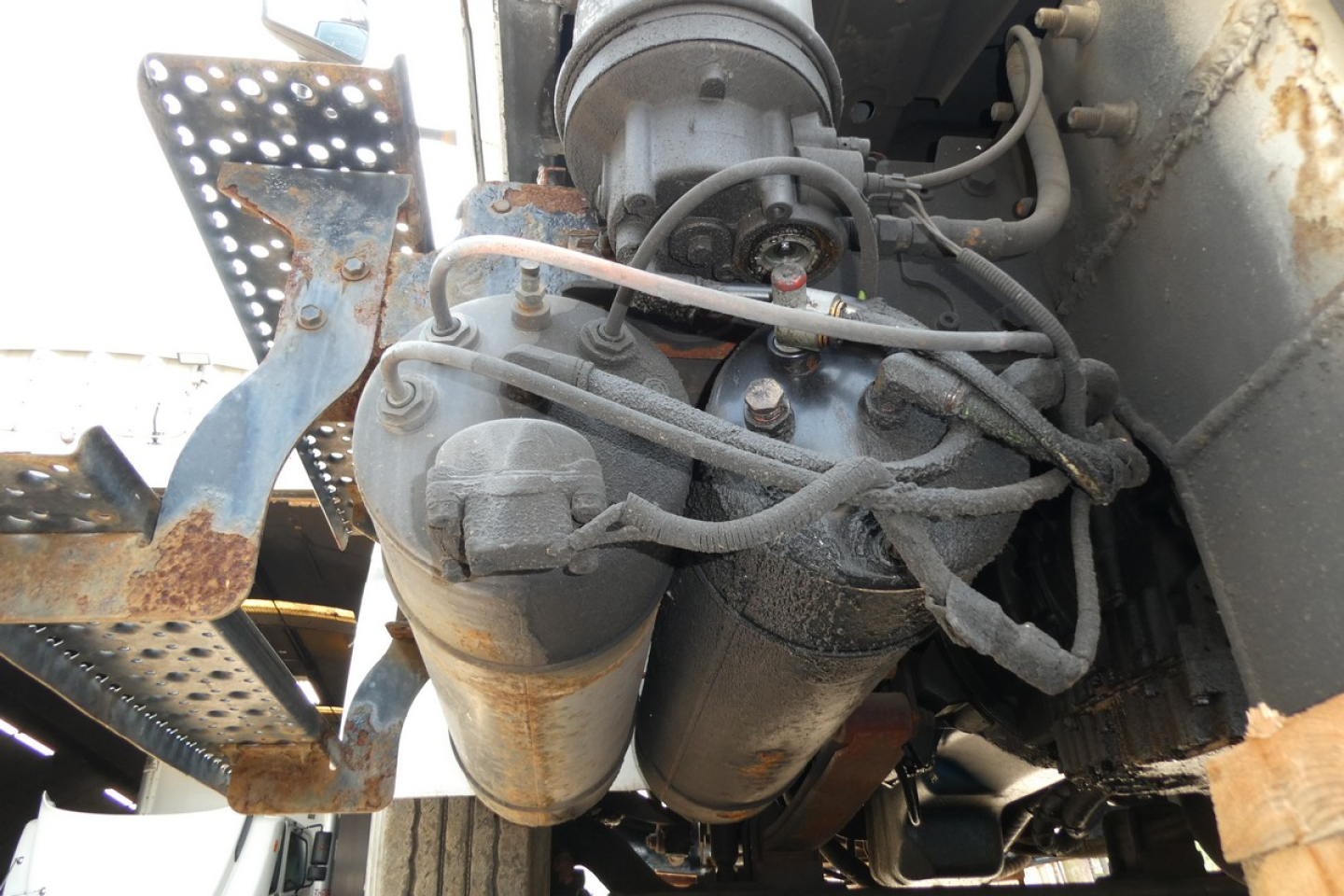Diesel engine bay of a 2005 International 4300 with exhaust aftertreatment filter and fuel lines visible