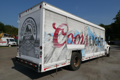 Box truck side view showing Cool Light branding, beverage delivery truck with 'Cool Light' logo and graphics on side and back doors.