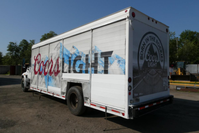 Box truck rear and side showing Coors Light beverage wrap and branding with white box body.