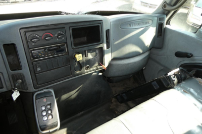 International truck cab interior showing dash with gauges, controls, and key switch.