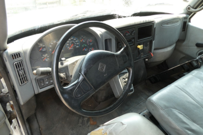 Truck cab interior of an International 4300 showing steering wheel and dashboard.