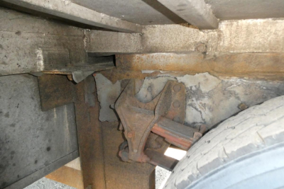 Suspension view of a 2005 International 4300 showing rear axle, leaf spring, and brake components under the chassis.