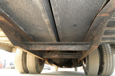 Underbody view of a 2005 International 4300 truck showing dual rear axle and fluids lines.