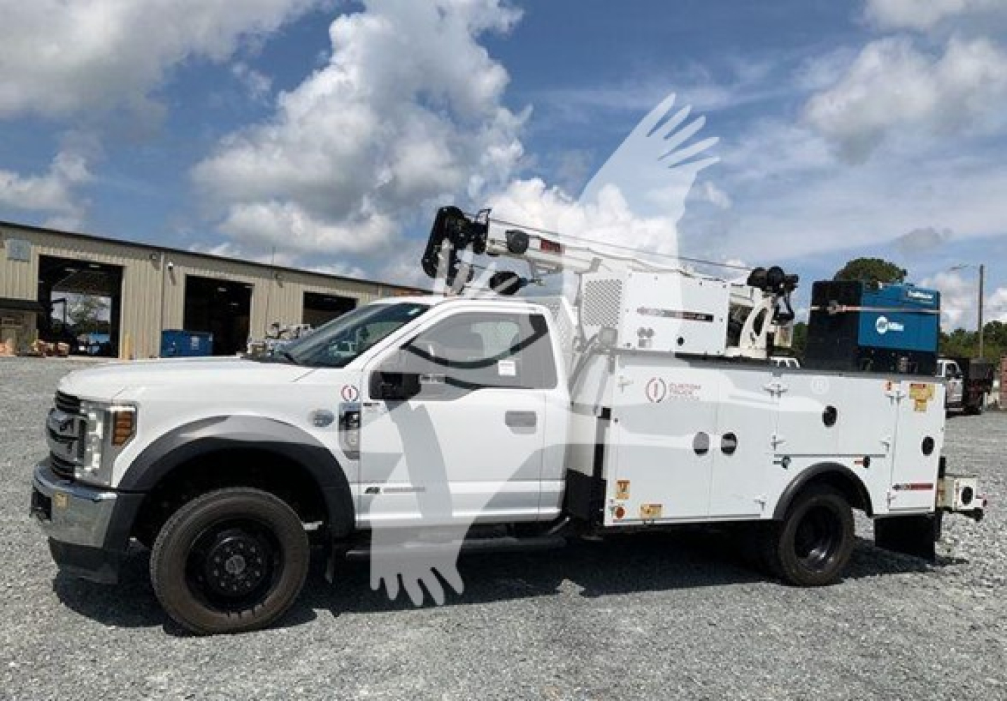  Ford F-550 service utility truck with bucket crane, side steps, and utility body; visible text includes company logos and equipment markings on doors and toolbox.