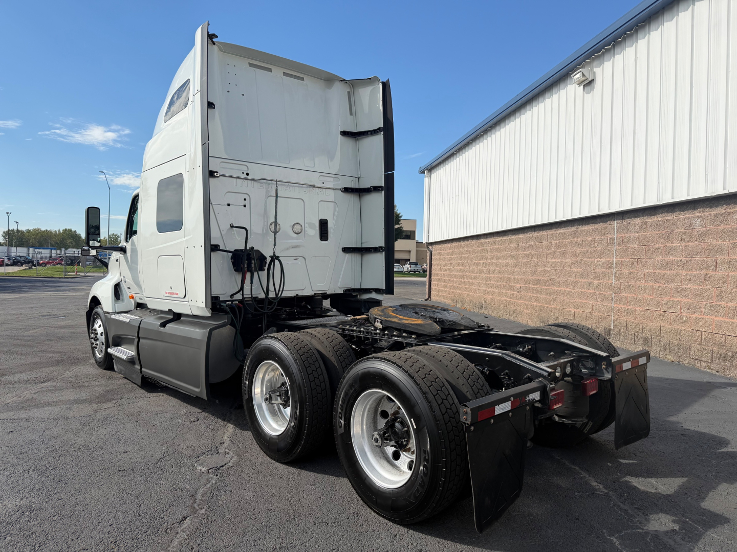 Truck chassis and cab of a 2021 International LT625 from a rear three-quarter view showing dual rear axles and fifth-wheel area.