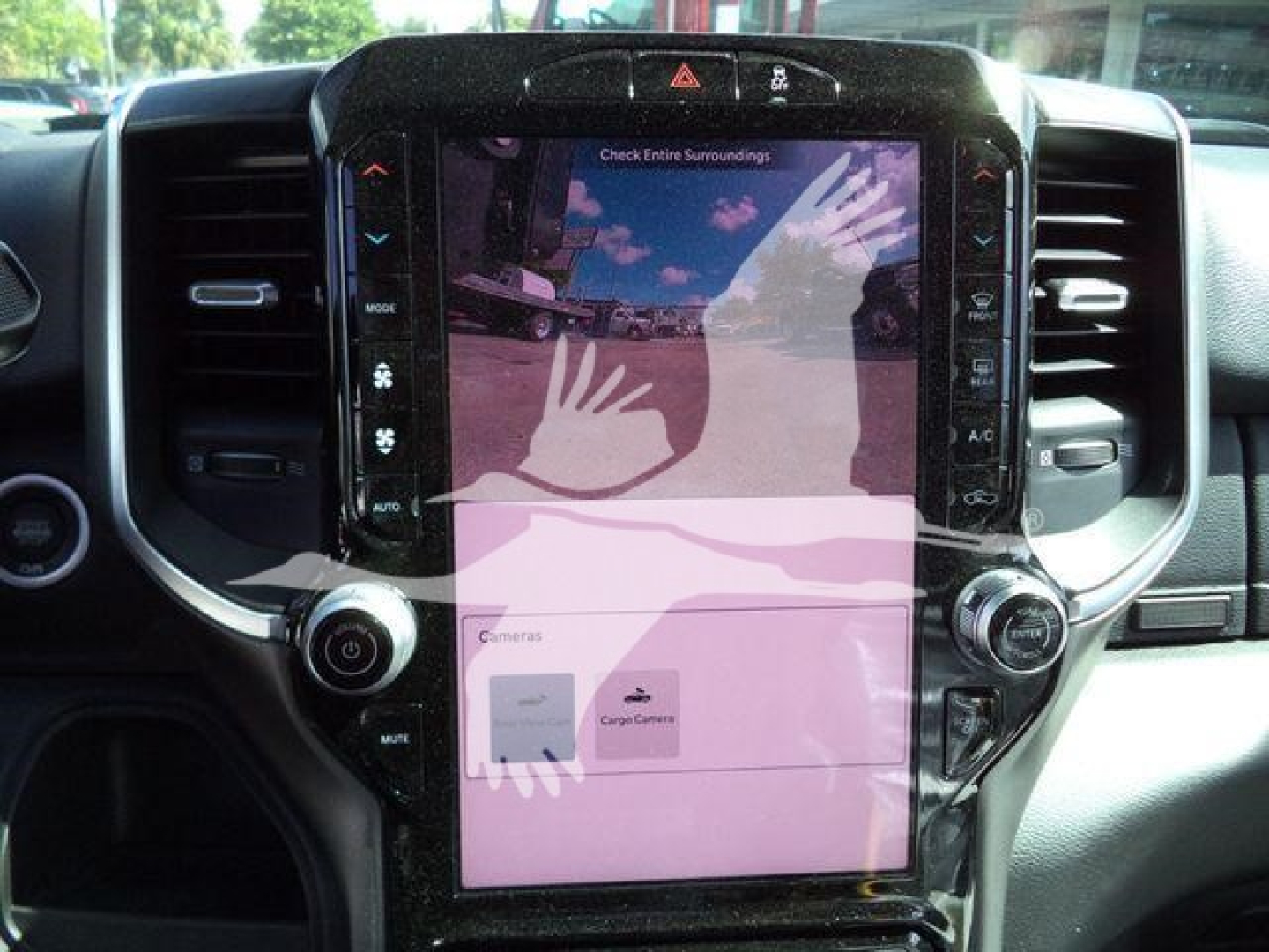 Ram 4500 dashboard center console with large vertical touchscreen display and surrounding control knobs.