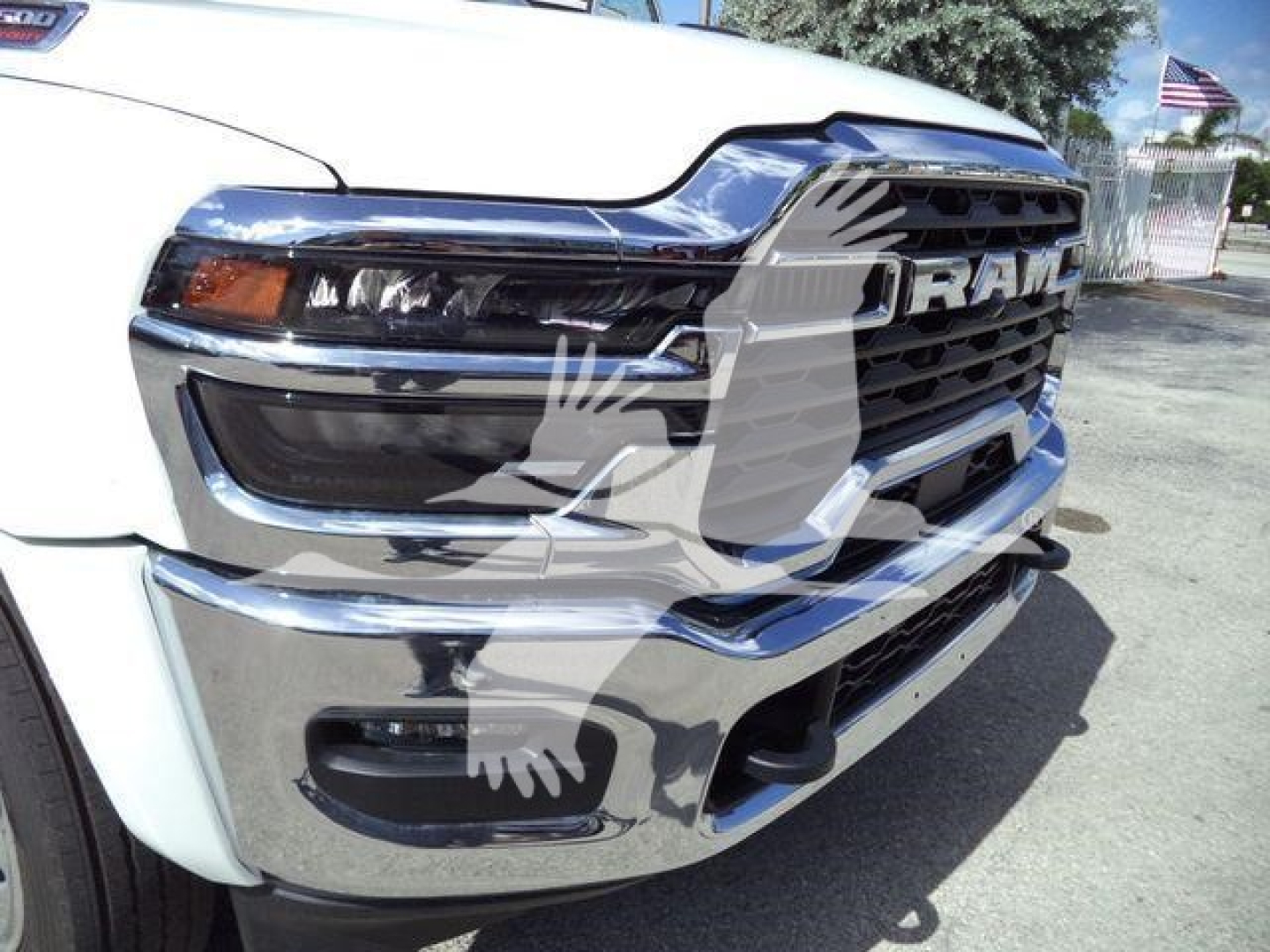 Ram 4500 front grille and headlight view showing RAM logo and chrome bumper in a white truck.