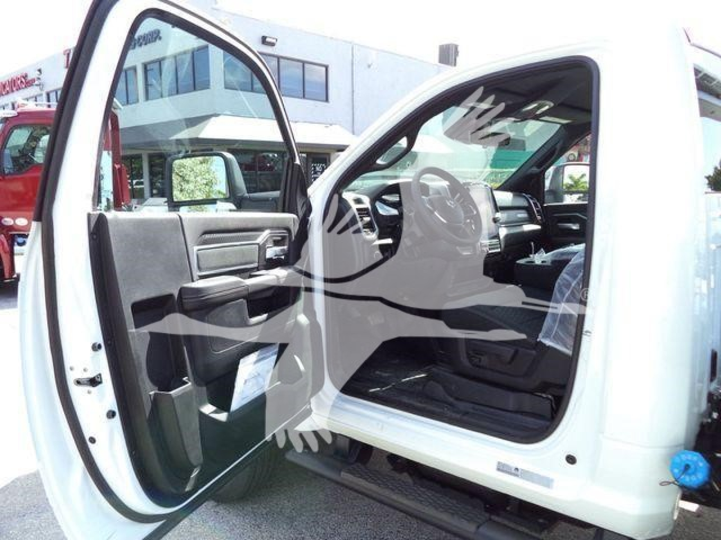 Ram 4500 cab interior view showing open front door, steering wheel, and dashboard with gray and black trim.