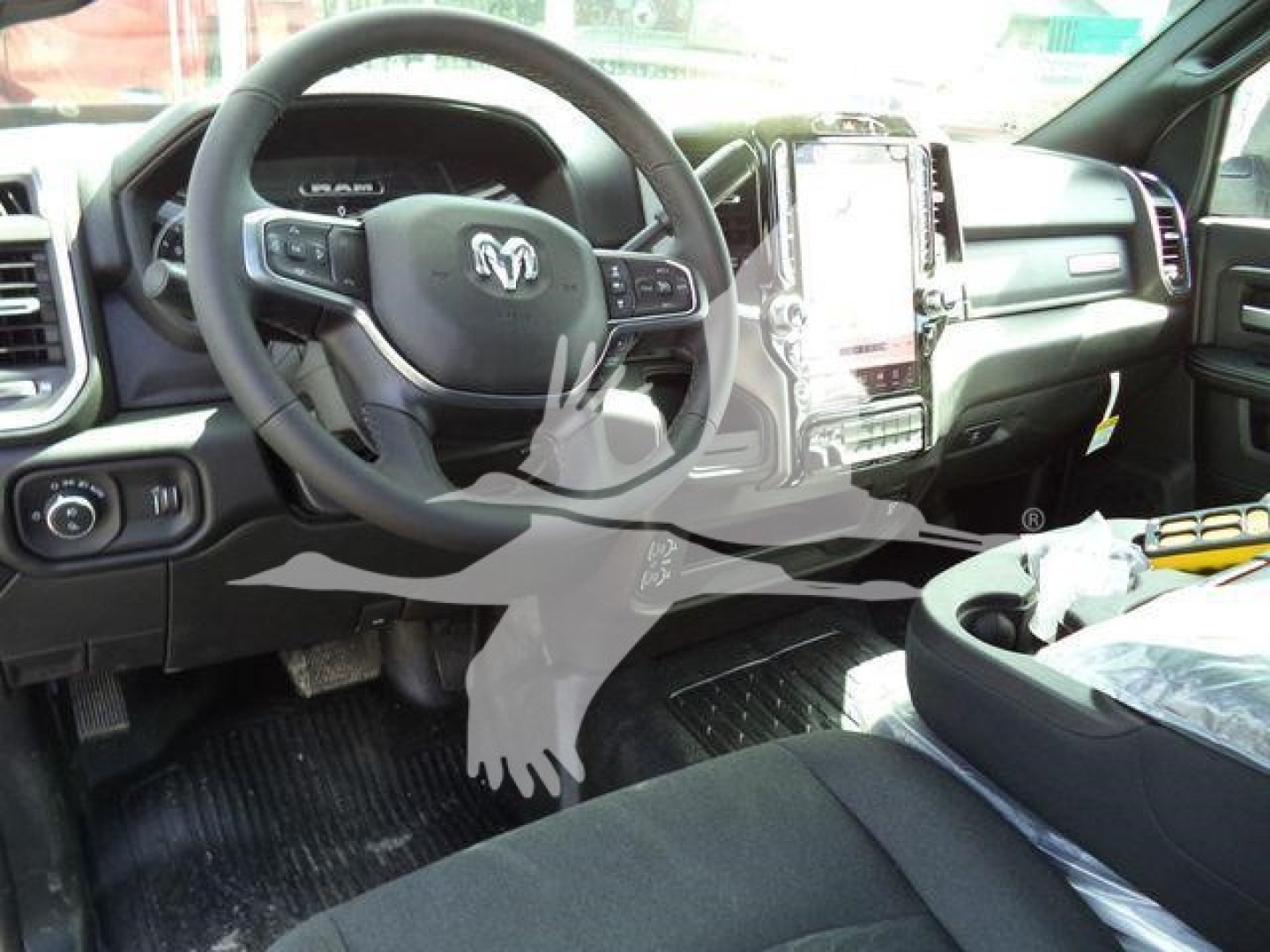 Ram 4500 interior showing steering wheel with Ram logo and large vertical touchscreen display in center console.